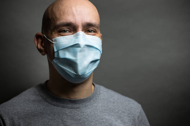 Young Man Wearing Surgical Mask And Smiling. - fotografia de stock