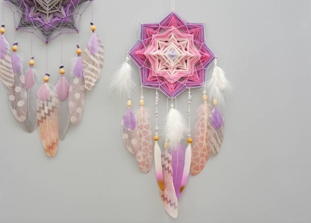 istock Mandala dream catcher with feathers and amethyst beads on grey background 1243375635