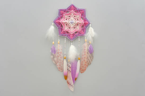 istock Mandala dream catcher with feathers and amethyst beads on grey background 1243376735