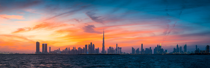 Sunset over Dubai skyline panorama landmark view from the Dubai creek harbor in the United Arab Emirates