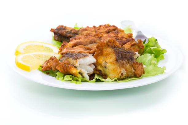 istock fried hake fish in batter with lettuce and lemon in a plate 1243381059
