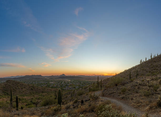 istock A desert trail on a mountain leading to a sunset over a valley in Phoenix 1243388541