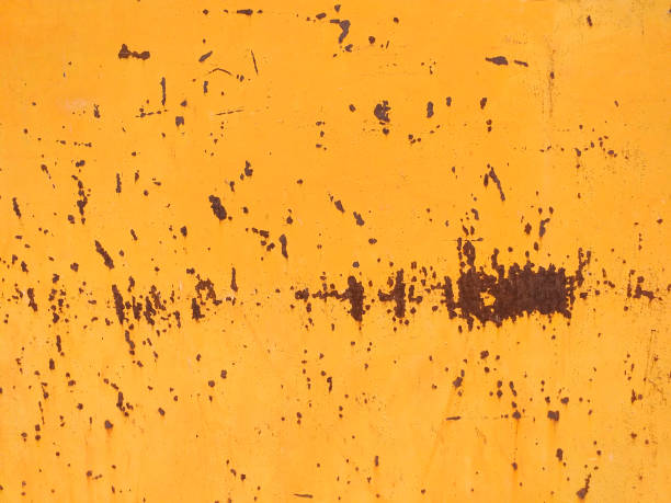 istock Peeling paint and rusty old metal background. Mustard colored rusty metallic abstract background. Patterns and texture. 1243390224