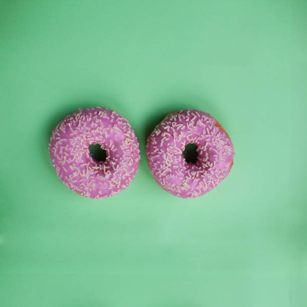 istock Donuts glazed with sprinkles on a blue background, copy space 1243392432