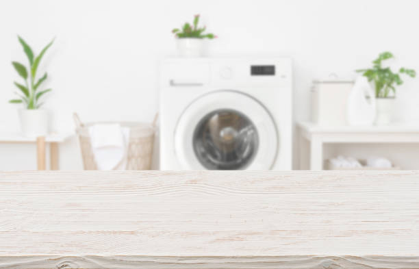 istock Mock-up for design of empty wooden table in laundry room 1243398546