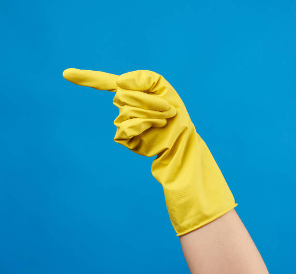 istock yellow rubber glove for cleaning dressed on a female hand 1243412452