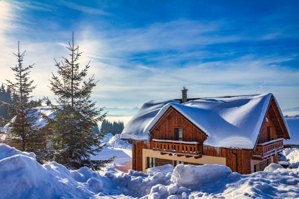 istock Winter landscape with a snow-covered wooden hut. 1243414207