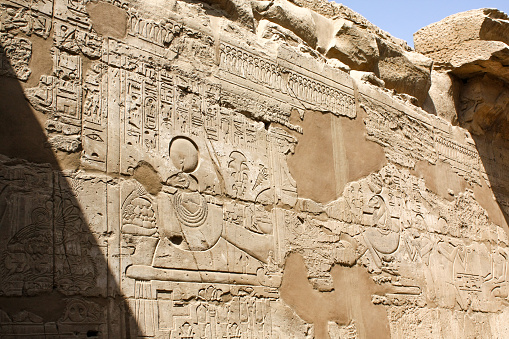 Karnak temple complex in Luxor, Egypt. Ruins of ancient temple, wall with a hieroglyphs.