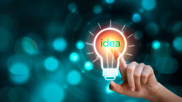 istock Hand touching the light bulb sign with idea text on blurred background. Creative innovation 1243419700