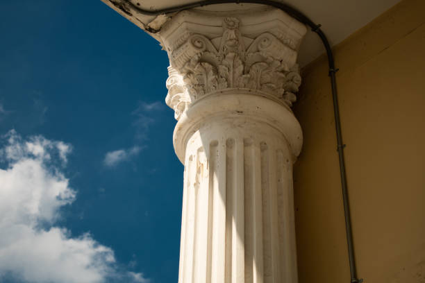 istock ancient greek columns with sun light and blue sky 1243436219