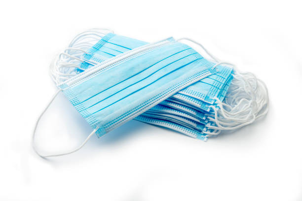 istock Blue medical masks on white background 1243437171