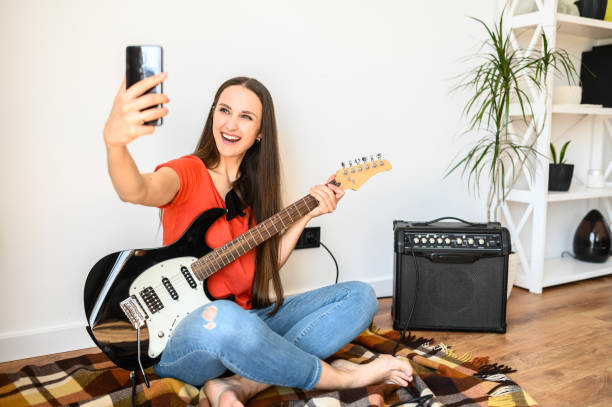 istock Woman makes selfie with an electric guitar 1243442530