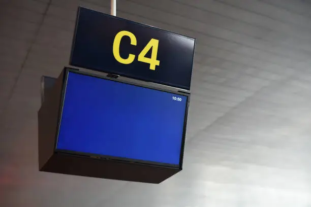 Blank airport information display on ceiling with number of gate C4