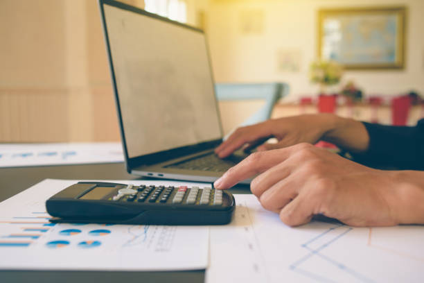 istock Businessman analysis on Graph data paper  using calculator, finance concept in office. 1243444841