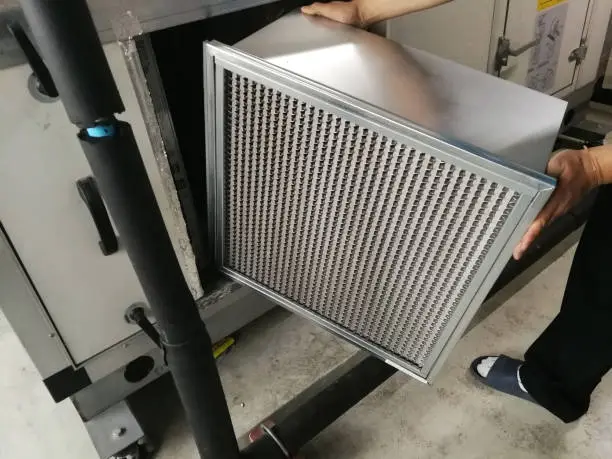Soft Focus to Filter of Air handing Unit, Technician checking a Medium -filter of air handling unit for replacement a new filter - HVAC maintenance