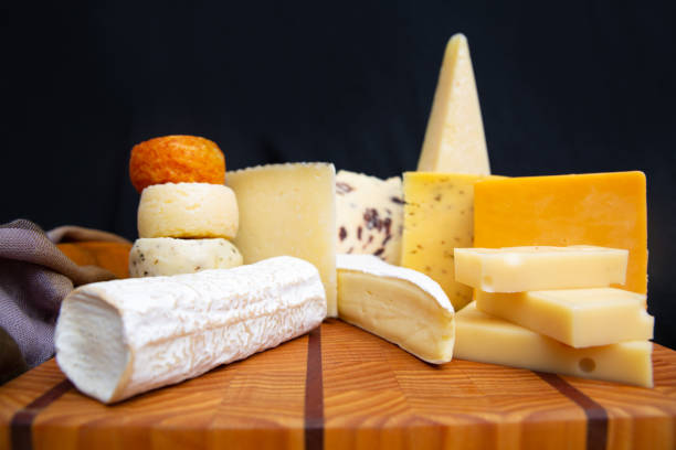 istock Tasty various cheeses laying on wooden board 1243453825