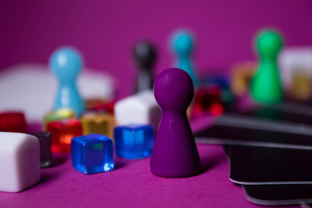 istock Elements - attributes for board games - figures, cards, cubes, bottles, points, houses, lives. On pink background. Isolated. Copy space. Exciting time with friends during isolation and quarantine 1243455479