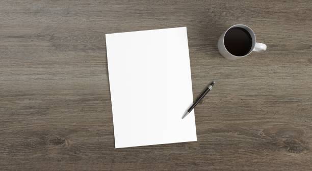 istock A4 paper, pen and cofee cup on wooden table 3D rendering 1243471168