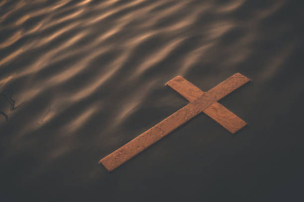 Floating wooden cross stock photo