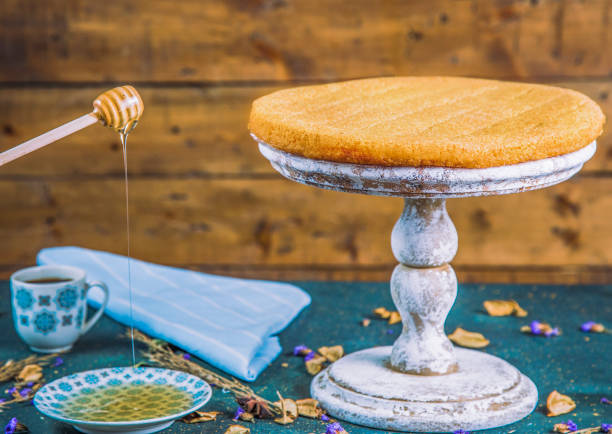 istock Syrupy tulumba arranged in plate with honey dipper 1243479938
