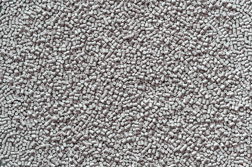 Gray polymer dye in granules, background texture.