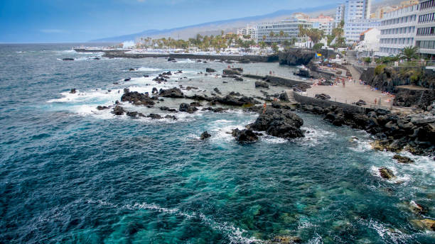 istock Beautiful view on ocean waves breaking on volcanic cliffs at seaside city 1243496202