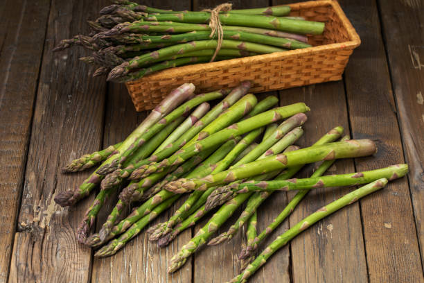 istock Bunch of fresh green asparagus spears on a rustic wooden table 1243496214