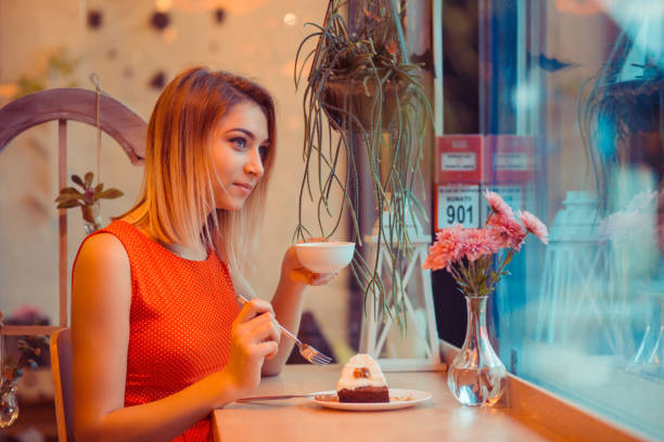 istock Woman at cafe thinking happy and smiling. cross-processed retro style image. 1243497941