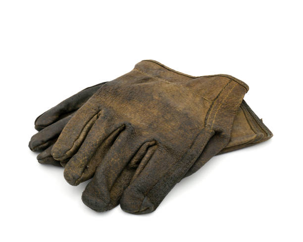 istock Old dirty leather gloves isolated on white background with clipping path 1243508427