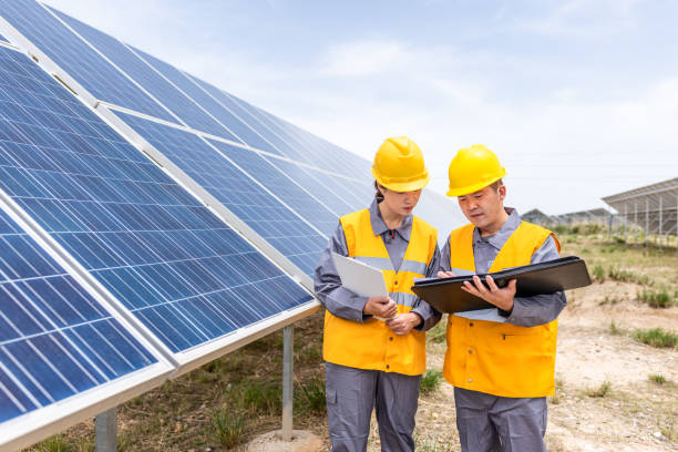 istock Two Asian power engineers working at the solar power station 1243514418