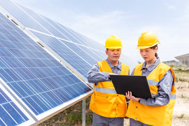 istock Two Asian power engineers working at the solar power station 1243517756