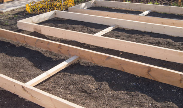 istock Wooden formwork from new boards for vegetable beds in the garden, preparation and construction, carpentry 1243528126