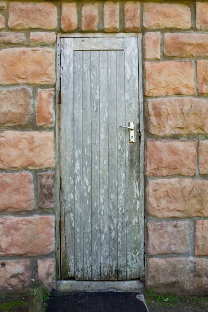 istock Old wooden door in a stone building 1243538441
