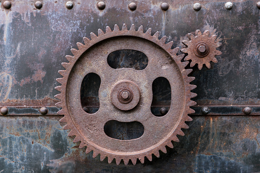 Rustic gearwheels on metal rusty background