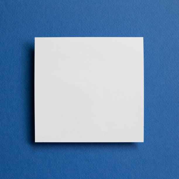 istock White memo pad, empty paper on dark blue background. top view, copy space 1243567225