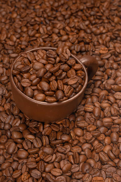 istock coffee cup with coffee beans on a background of coffee beans 1243569890