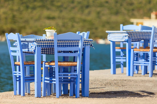 istock Open cafe outdoor restaurant in Greece on sea shore 1243588906