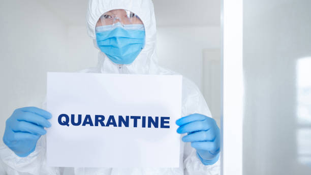 istock Doctor in PPE suit showing paper quarantine 1243599460