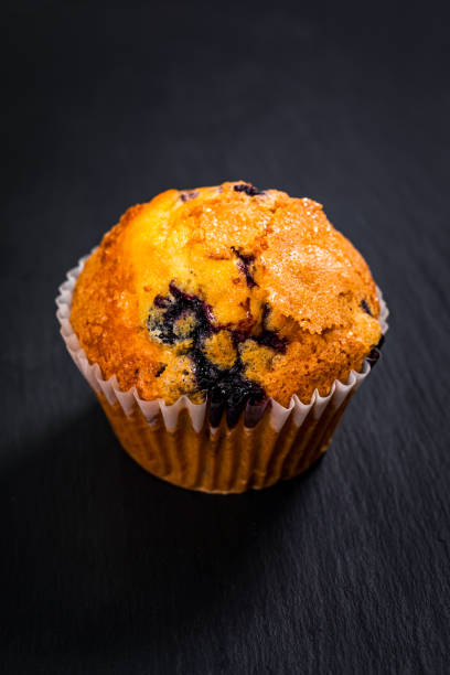 istock Muffin with Blueberries on Black Chalkboard with Copy Space 1243619830