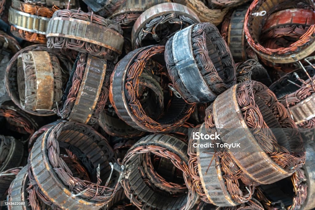 scrap yard of stator plate and wingdings in ac alternators for recycling. copper recycling from stator. stator plate and wingdings in ac alternators for recycling. copper recycling from stator. Scrap Metal Stock Photo