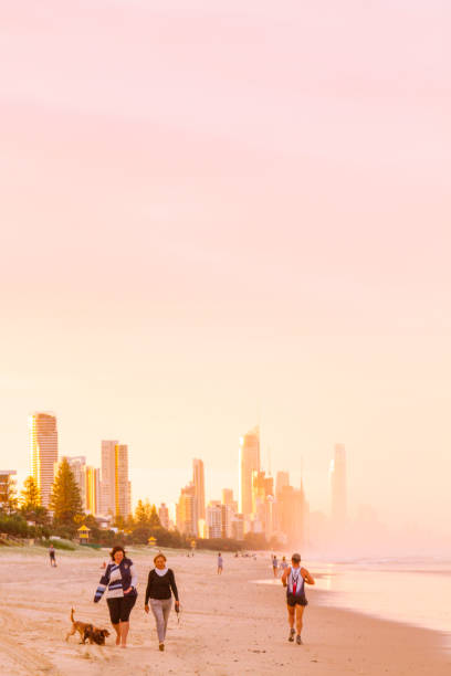 April 29, 2018 - Broadbeach, Gold Coast, Queensland, Australia: People enjoying the beach with a beautiful sunset, on back Gold Coast's skyline.