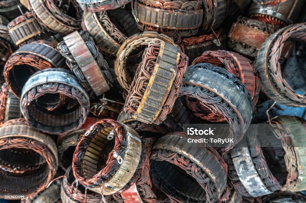 scrap yard of stator plate and wingdings in ac alternators for recycling. copper recycling from stator. Magnet Stock Photo