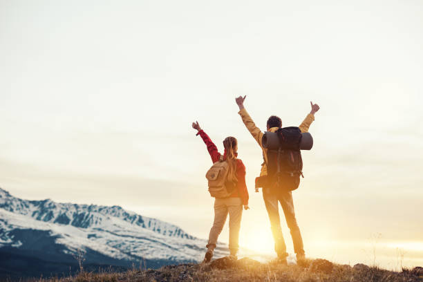 istock Two happy hikers at mountains sunset 1243631855