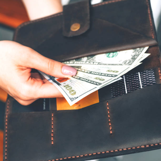istock Wallet with dollar bills in female hands. 1243638947