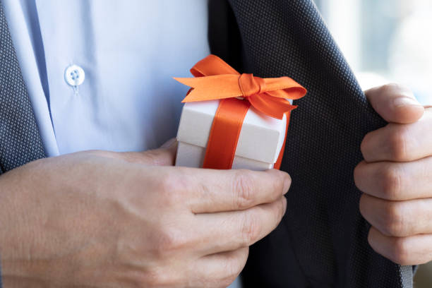 istock Businessman giving Gift Box 1243645002