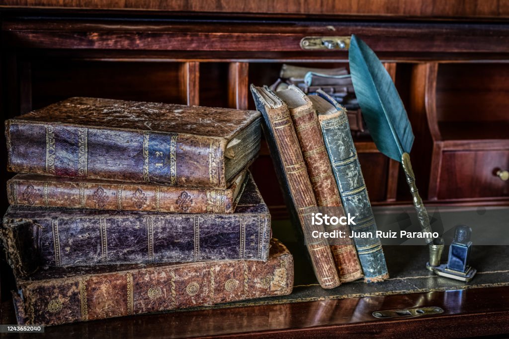 old books on desk and pen writing Spain Stock Photo