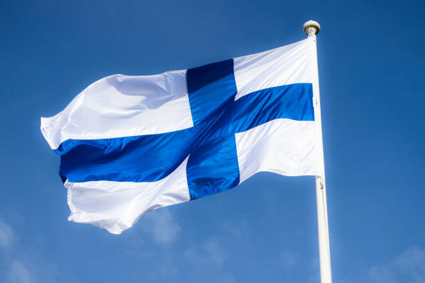 istock Finnish national flag on the wind against the blue sky 1243669074