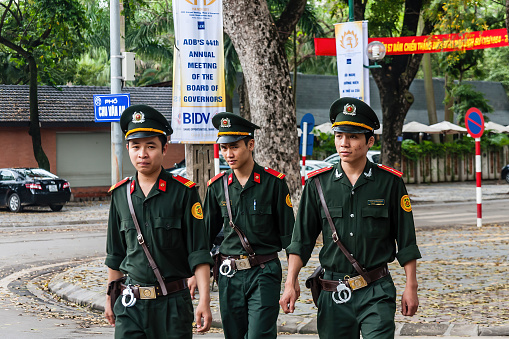 A three-men police patrol in the downtown of Hanoi