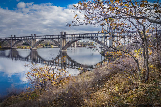 istock Autumn tree on the background of the bridge 1243690936
