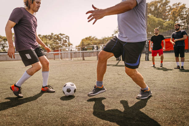 istock Men in action during soccer match on field 1243694000